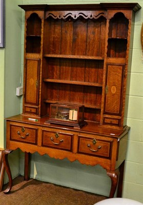 Lot 1326 - An oak and mahogany crossbanded dresser, the rack of inverted breakfront form with pierced and...