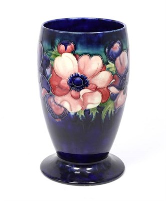 Lot 103 - A Walter Moorcroft Anemone pattern vase, on a blue ground with impressed factory marks and...