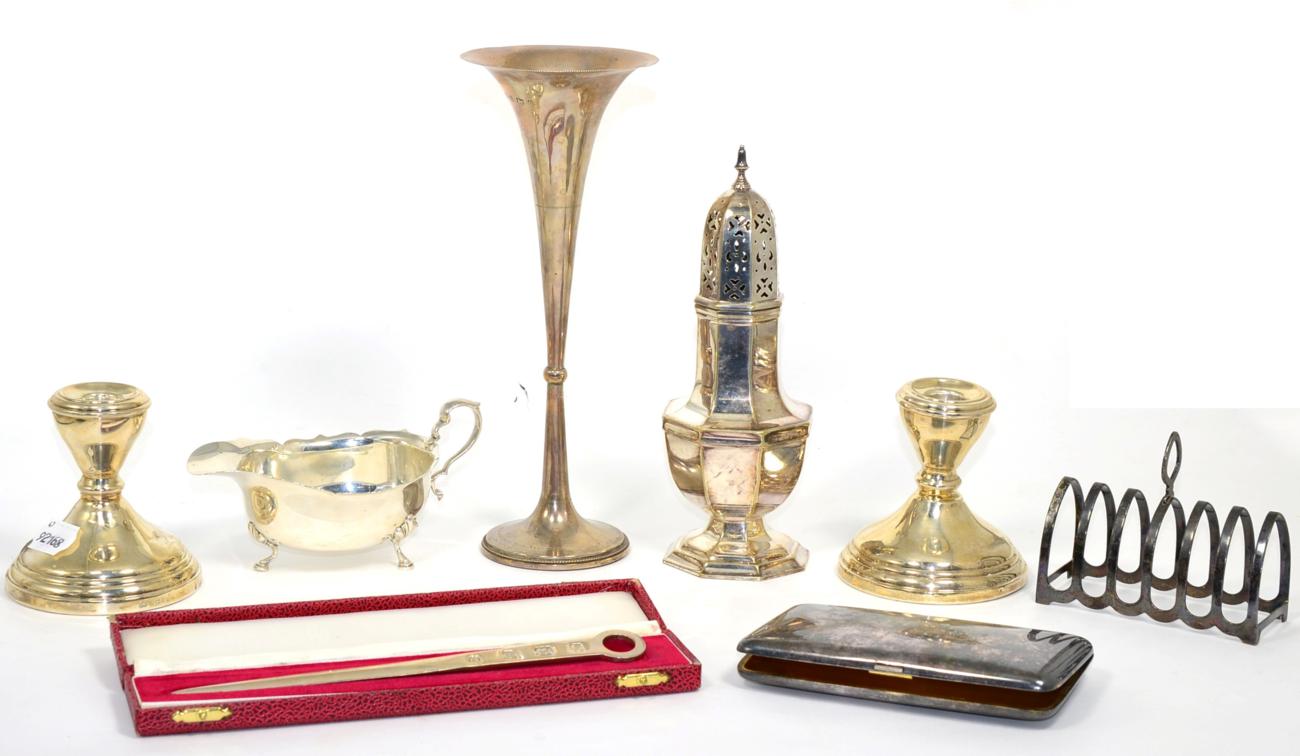Lot 11 - Assorted silver items comprising: a pair of candlesticks Elkington & Co, 1967; a sauceboat, 1930; a