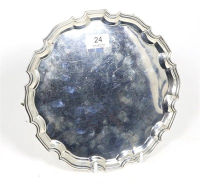 Lot 24 - A shaped circular silver salver, Stower & Wragg, Sheffield 1941, on three scroll supports,...