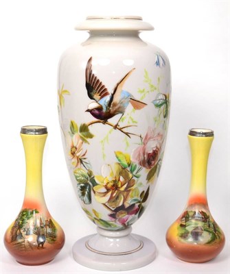 Lot 31 - A Continental opaque glass vase painted with a garden bird perched on a branch amongst flowers;...