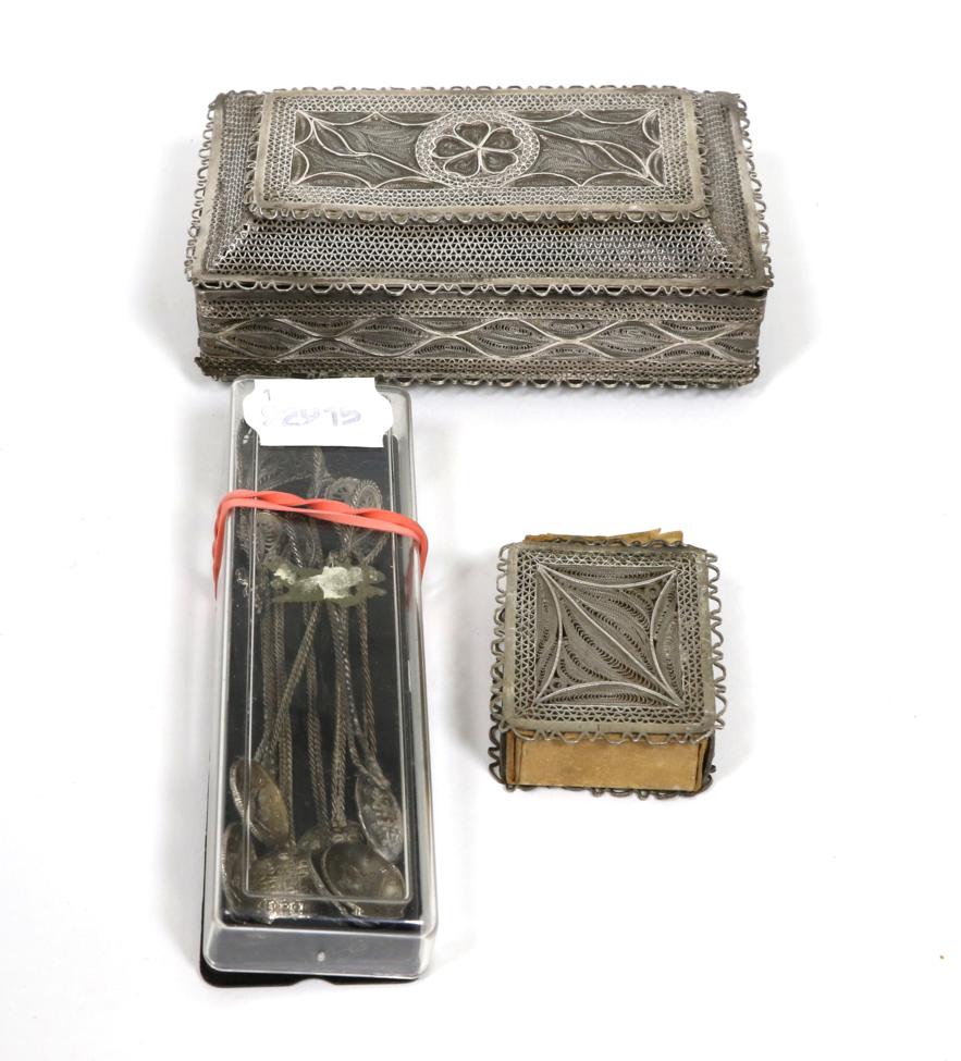 Lot 54 - A filigree white metal box and cover; a similar match box holder; and a set of spoons with coin...