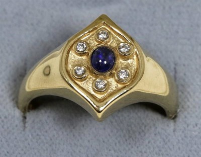 Lot 56 - A 9 carat gold sapphire and diamond cluster ring, an oval cabochon sapphire within a border of...