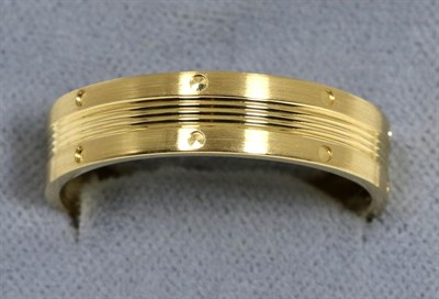 Lot 64 - An 18 carat gold band ring, with engraved detail, finger size W1/2