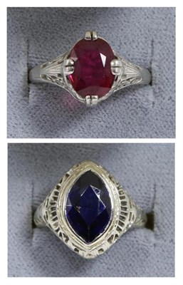 Lot 80 - A synthetic sapphire ring, a marquise cut synthetic sapphire in a rubbed over setting, to a pierced