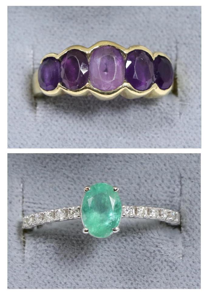 Lot 96 - An emerald and diamond ring, an oval cut emerald in a claw setting, to diamond set shoulders, total