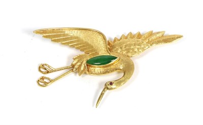 Lot 97 - A jade and ruby crane brooch, modelled in a flying pose, with textured feathers, inset with a...