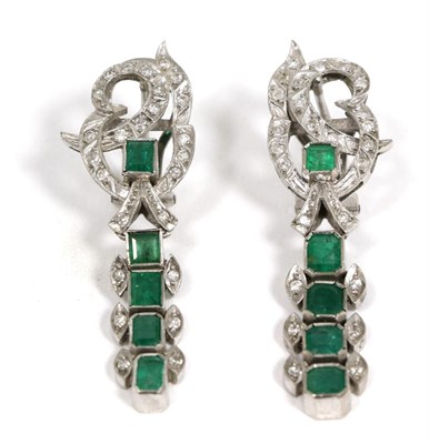 Lot 99 - A pair of emerald and diamond pendant earrings, eight-cut diamond set scroll tops suspend a row...
