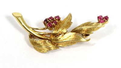 Lot 105 - A ruby spray brooch, clusters of round cut rubies to textured leaves, measures 4.3cm by 1.5cm