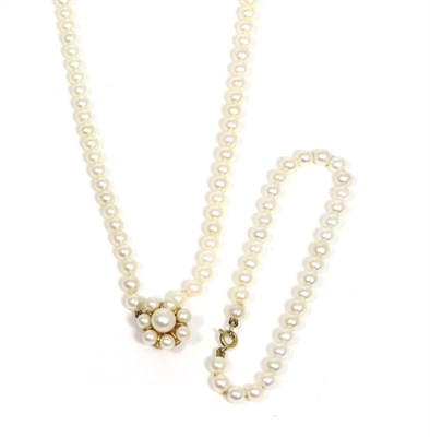 Lot 109 - A cultured pearl necklace' two stands of uniform cultured pearls, knotted to a 14 carat gold...