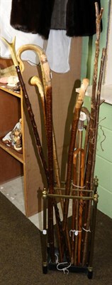 Lot 148 - Thirteen various walking sticks and thumb sticks; a brass stick stand