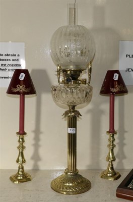 Lot 150 - A brass column oil lamp and a pair of candlesticks