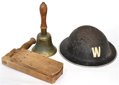 Lot 202 - A World War II warden's helmet; gas rattle; and 'All Clear' bell, marked A.R.P