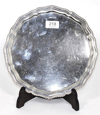 Lot 218 - A George III style silver salver, Harrison Fisher & Co, Sheffield, 1933, with gadroon border and on