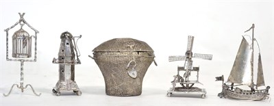 Lot 256 - Two Dutch silver miniature models of windmills; a Dutch silver model of a boat; a model of a...
