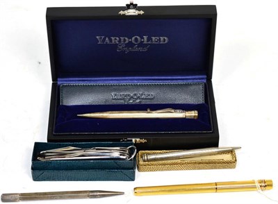 Lot 261 - A silver Yard-O-Led pencil, in box and packaging; a Must de Cartier ball point pen; another...