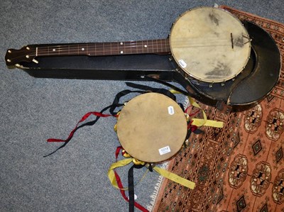 Lot 1014 - A four string banjo and a tambourine