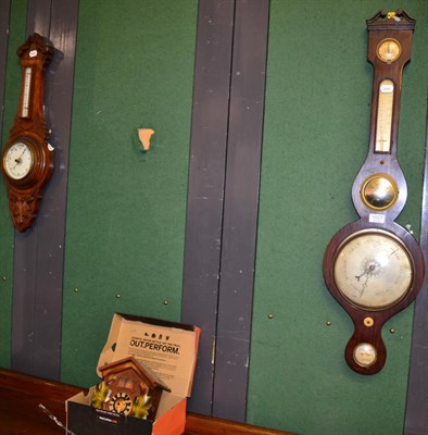 Lot 1027 - A rosewood wheel barometer, a modern cuckoo wall clock and an oak cased aneroid barometer (3)