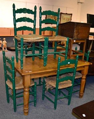 Lot 1041 - A pine kitchen table together with six green painted rush seated dining chairs (7)