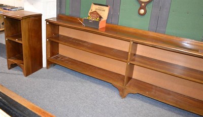Lot 1045 - A large open bookcase comprising four shelves and a two tier open book cabinet