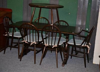 Lot 1058 - An Ercol elm refectory table, six chairs and a coffee table (8)