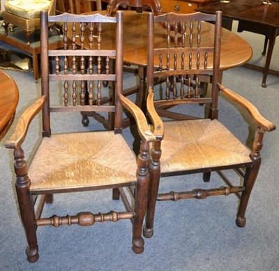 Lot 1077 - A Victorian walnut breakfast table and two Lancashire spindle back chairs (3)