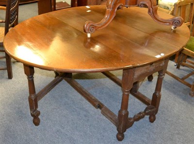 Lot 1078 - An oak 18th century style gateleg dining table