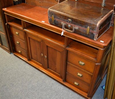 Lot 1081 - A mahogany side cabinet consisting of two small central doors and six side drawers