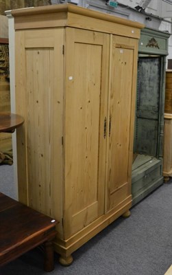 Lot 1098 - A reproduction pine wardrobe and a green painted coat stand