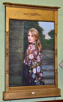 Lot 1138 - John Blakey (b.1952), Portrait of a young lady, three quarter length, wearing a pink floral...