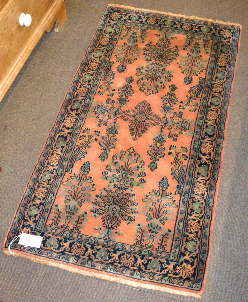 Lot 1176 - Saroukh Rug, West Iran, the rust field of semi naturalistic plants enclosed by meandering vine...