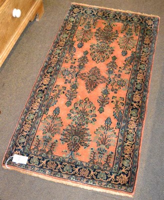 Lot 1176 - Saroukh Rug, West Iran, the rust field of semi naturalistic plants enclosed by meandering vine...