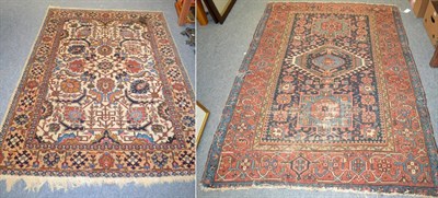 Lot 1182 - Heriz rug, Iranian Azerbaijan, the indigo field with three medallions enclosed by madder...