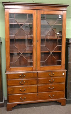 Lot 1199 - A mahogany glazed bookcase raised upon a later mahogany base comprising one long drawer and six...