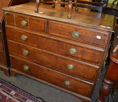 Lot 1231 - An early 19th century oak chest of drawers comprising four long drawers and two short drawers