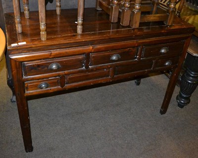 Lot 1314 - A 20th century sideboard with three long drawers above two short drawers