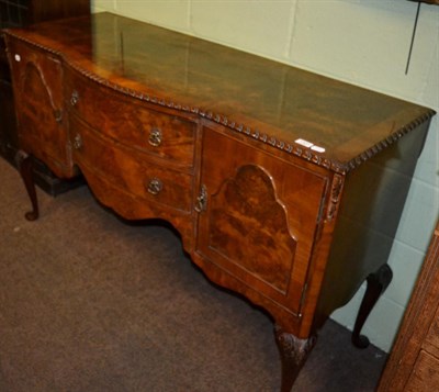 Lot 1320 - A 20th century burr walnut veneered sideboard, with two central drawers and two side doors