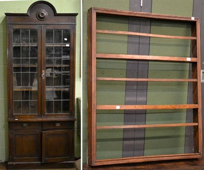 Lot 1322 - A 20th century glazed bookcase with two doors and a cupboard beneath together with an oak wall...