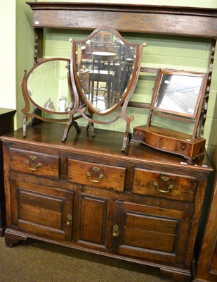 Lot 1325 - An 18th century oak enclosed dresser and rack, with two shelves and shaped end supports, the...