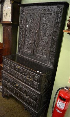 Lot 1330 - A Victorian carved oak bookcase with single drawer to the base