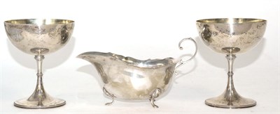 Lot 10 - A pair of silver wine cups with gilt interiors, marked for London together with a silver sauce boat