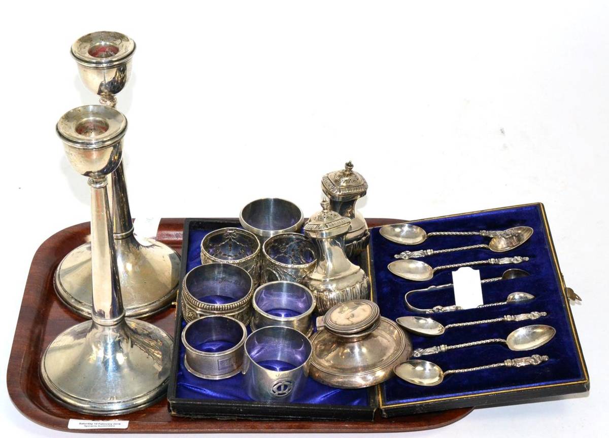 Lot 25 - A cased set of six silver apostle spoons with matching tongs, seven various silver napkin...