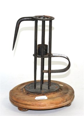 Lot 27 - An early adjustable birdcage candlestick, on a split turned wood base