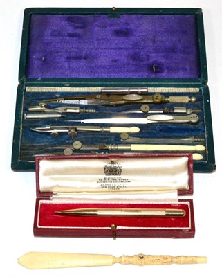 Lot 80 - An Asprey 9 carat gold engine engraved propelling pencil, cased; a Stanhope viewer and a set of...