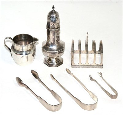 Lot 116 - A group of silver comprising, an octagonal baluster caster, a four division toast rack, cream...