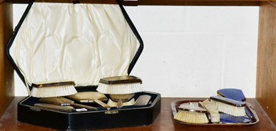 Lot 143 - A cased Art Deco silver five piece dressing table set, Birmingham 1929, with engine turned...