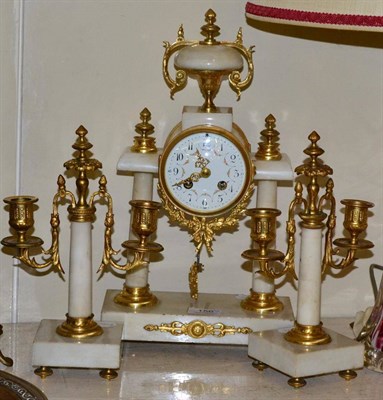 Lot 156 - A portico striking mantel clock with garniture