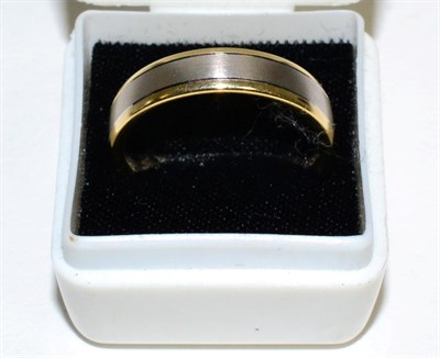 Lot 167 - An 18 carat two colour gold band ring, finger size T