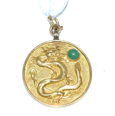 Lot 179 - A Chinese 'Good Fortune' pendant, circular with the motif of a dragon chasing a jade cabochon...