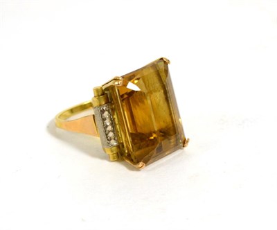 Lot 194 - A citrine ring, an octagonal cut citrine in a double claw setting, to fancy scroll shoulders,...